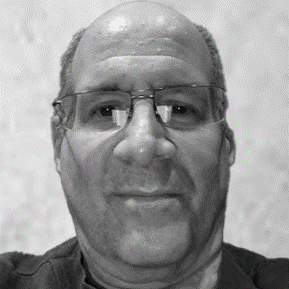 A black and white photo of a man with glasses.